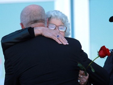 Gordie Howe's sister Viola Watson gives Marty Howe a hug before the ashes of Gordie and his wife Colleen are interred at Howe's statue at SaskTel Centre on September 25, 2016.