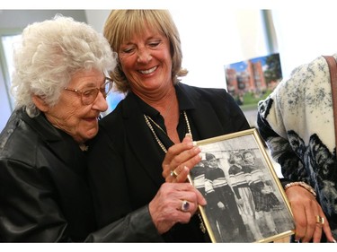 Gordie Howe's sister Viola Watson and daughter Cathy Howe hold up a childhood photo of him in King George school, where he attended school as a child in Saskatoon on September 25, 2016.