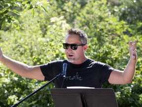 Todd Lyons, with daughter Georgia in the rickshaw, attended a Keep Meewasin Vital rally at Gabriel Dumont Park. Lyons said he regularly runs the trails.