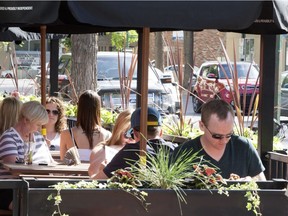 Patrons enjoy the sidewalk patio at Hudsons in downtown Saskatoon.