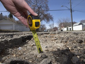 SASKATOON,SK--MARCH 16/2015-- Some potholes are deep enough to be damaging, like this one on 16th Street West, Thursday, April 16, 2015(GREG PENDER/STAR PHOENIX)