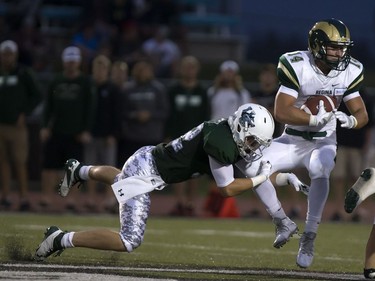 U of S Huskies' Bowan Lewis wraps up Regina Rams' Ryan Schienbein in CIS University football action at Griffiths Stadium in Saskatoon, September 2, 2016.