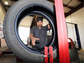 Tire Tech Ron Wuttunee works on a tire at the Market Tire on Packham Aveue, Friday, September 02, 2016.