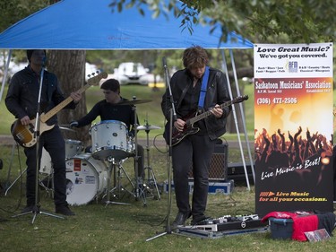 People lined up in Victoria Park for burgers and drink, along with live music and balloons, September 5, 2016, during the Saskatoon & District Labour Council's Labour Day BBQ in the park.