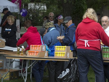 People lined up in Victoria Park for burgers and drink, along with live music and balloons, September 5, 2016, during the Saskatoon & District Labour Council's Labour Day BBQ in the park.