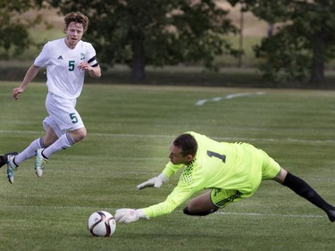 Goalie Dylon Powley of the Grant McEwan Griffins (R) makes the save on a shot fromMitchell Bauche of the University of Saskatchewan Huskies in CIS soccer action at PotashCorp Park in Saskatoon, September 9, 2016.