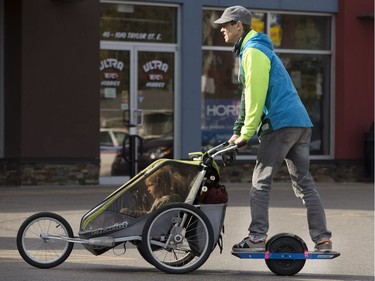 Jonathan Storey uses an electric "one wheel" to power himself and a stroller with youngsters Sam Ross and Jack Storey on an outing down Taylor Street East , September 21, 2016.