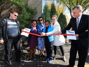 READ Saskatoon hosted the grand opening of their new location at 706 Duchess Street. Cutting a ribbon to mark the event were, Clint Broten, left, adult literacy award winner; Sthandiwe Masilela and mother Masesi Masilela and son Mpumelelo Masilela; Sheryl Harrow-Yurach, Executive Director, READ Saskatoon; and Honourable Don Morgan, Saskatchewan's Deputy Premier and Minister of Education, Thursday, September 22, 2016.