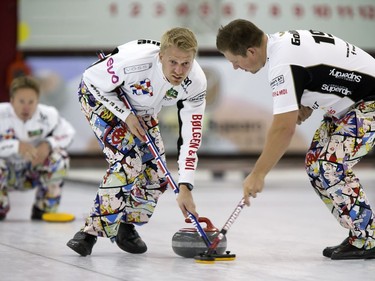 Sweepers Havard Vad Petersson and Christoffer Svae of Team Ulsrud in action during the championship final in the World Curling Tour's College Clean Restoration Curling Classic at the Nutana Curling Club, September 26, 2016.