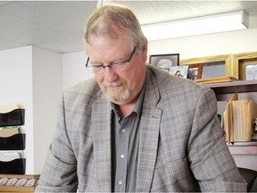 Sunset Cemetery manager Marc L'Hoir looks at blueprints of a potential Bible theme park that could be built near the city of Moose Jaw. William Stodalka/Moose Jaw Times-Herald.