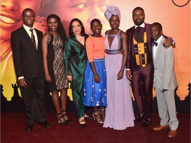 L-R: Chess Coach and Director of Sports Outreach in Uganda Robert Katende, Ugandan national chess champion Phiona Mutesi, director Mira Nair, actors Madina Nalwanga, Lupita Nyong'o, David Oyelowo and Martin Kabanza arrive at the U.S. premiere of Disney's "Queen of Katwe" at the El Capitan Theatre in Hollywood, California, September 20, 2016.