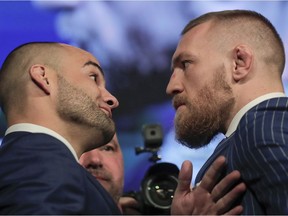 UFC lightweight champion Eddie Alvarez, left, and featherweight champion Connor McGregor, right, pose for photos during a new conference for UFC 205, Tuesday, Sept. 27, 2016, in New York. McGregor and Alvarez will headline the first UFC card to be held in the state since the state legislature legalized the sport earlier this year. UFC 205 is scheduled for Nov. 12.