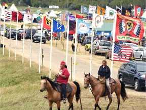 Flags of Native American tribes from across the U.S. and Canada line the entrance to the encampment near Cannon Ball, North Dakota.