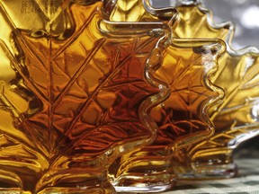 FILE - In this Oct. 27, 2011 file photo, bottles of maple syrup sit in a window in East Montpelier, Vt. The U.S. Department of Agriculture said maple syrup production was up in the 2015 season. Vermont continues to lead the nation by far, producing most of the syrup in the country, followed by New York and Maine. (AP Photo/Toby Talbot, File) ORG XMIT: POS1506171040401329