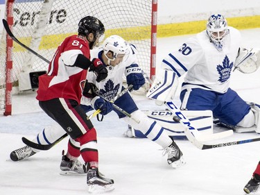 Toronto Maple Leafs goalie Antoine Bibeau makes a save as defenceman Frank Corrado and Ottawa Senators centre Phil Varone look on during the third period of an NHL pre-season hockey game in Saskatoon, October 4, 2016.