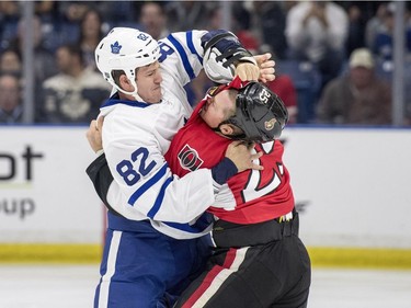 Toronto Maple Leafs forward Brandon Prust and Ottawa Senators right wing Chris Neil fight during the first period of an NHL pre-season hockey game in Saskatoon, October 4, 2016.