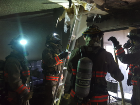 Saskatoon firefighters work in an apartment where a fire caused an estimated $200,000 damage.