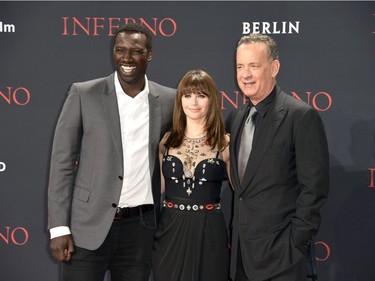 L-R: Omar Sy, Felicity Jones and Tom Hanks attend the German premiere of "Inferno," at the CineStar cinema, in the Sony Centre in Berlin, Germany, October 10, 2016.