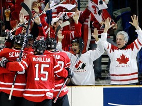 Fans and players celebrate a Team Canada goal at the 2010 world junior hockey championship in Saskatoon.