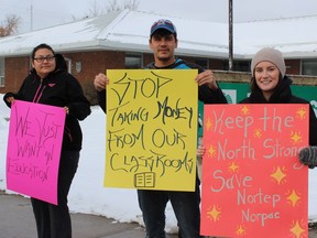 Northern Teacher Education Program (NORTEP) students rallied in La Ronge and Regina on Wednesday, protesting Saskatchewan government plans to change funding for the program. From left to right, students Lorna Clarke, Lyndon Cook and Kaila Larson carried signs in La Ronge.