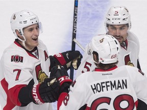 Ottawa Senators' Mike Hoffman celebrates with teammates Kyle Turris and Cody Ceci after scoring against the Montreal Canadiens during overtime period NHL pre-season hockey action in Montreal on Sept. 29.