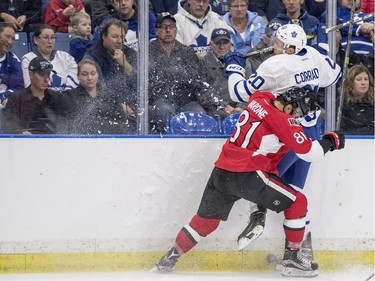 Ottawa Senators centre Phil Varone hits Toronto Maple Leafs defenceman Frank Corrado into the boards during the first period of an NHL pre-season hockey game in Saskatoon, October 4, 2016.