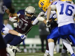 Regina Thunder running back Victor St. Pierre-Laviolette is hauled down by the Saskatoon Hilltops defence at old Mosaic Stadium in Regina, Sask. on Saturday Oct. 1, 2016. MICHAEL BELL