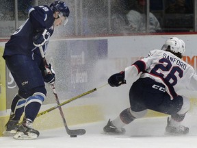 Blades Ryan Graham gets snowed by Pats Cole Sanford 26 during WHL action between the Regina Pats and Saskatoon Blades in March
