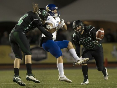 U of S Huskies' Ben Whiting (L) knocks the ball away from UBC Thunderbirds' Will Watson during Canada West clash in Saskatoon on October 14, 2016.