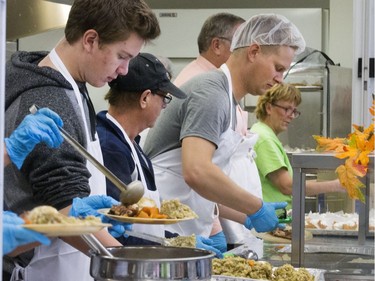 All hands on deck at the annual Thanksgiving Day meal at the Friendship Inn where more than 20 volunteers of all ages, along with staff members, served dinner to the needy that were seated, lined up inside and outside waiting for a warm turkey meal, October 10, 2016.