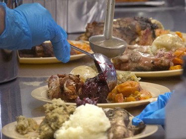 All hands on deck at the annual Thanksgiving Day meal at the Friendship Inn where more than 20 volunteers of all ages, along with staff members, served dinner to the needy that were seated, lined up inside and outside waiting for a warm turkey meal, October 10, 2016.