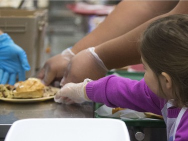 All hands on deck at the annual Thanksgiving Day meal at the Friendship Inn where more than 20 volunteers of all ages, along with staff members, served dinner to the needy that were seated, lined up inside and outside waiting for a warm turkey meal, October 10, 2016.