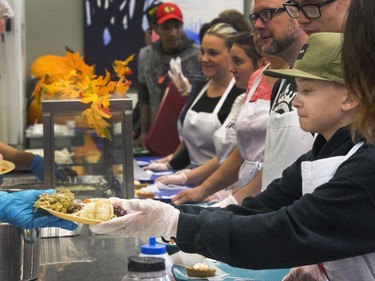 All hands on deck at the annual Thanksgiving Day meal at the Friendship Inn where more than 20 volunteers of all ages, along with staff members, served dinner to the needy that were seated, lined up inside and outside waiting for a warm turkey meal, October 10, 2016.