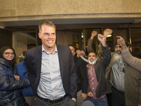 The new mayor of Saskatoon, Charlie Clark, and a large group of supporters arrive at City Hall, October 26, 2016.