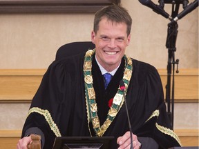 Saskatoon's new mayor Charlie Clark chuckles while tapping the gavel a couple times in fun after completing the swearing in of him and the newly elected city council, October 31, 2016.