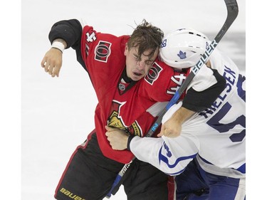 Ottawa Senators #44 Jean-Gabriel Pageau takes a shot in the back of the head in a fight with Toronto Maple Leafs #58 Andrew Neilson in second period NHL exhibition play at SaskTel Centre in Saskatoon, October 4, 2016.