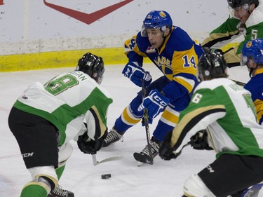 Saskatoon Blades #14 Jesse Shynkaruk weaves his way through the Prince Albert Raiders players on his way for a shot on the Raiders net in first period WHL action in Saskatoon, October 6, 2016.
