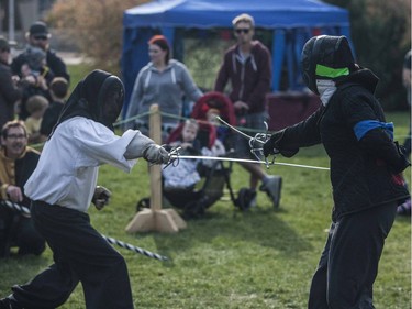 Two swordsmen recreate traditional battle scenes in front of a crowd during the Prairie Paladin Medieval Market and Faire located at the University of Saskatchewan in Saskatoon, October 1, 2016.