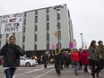 A crowd marches downtown to protest inadequate funding for the Lighthouse in Saskatoon.
