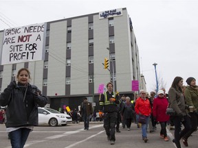 A crowd marches downtown to protest inadequate funding for the Lighthouse in Saskatoon.