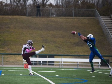 Bishop J. Mahoney Saints #45 Mathew Todos attempts to block a kick from a Marion Graham Falcons player during the Saskatoon 3A high school football finals at SMF Field in Saskatoon, October 29, 2016.