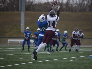 Bishop J. Mahoney Saints #80 Ethan Godson and Marion Graham Falcons #14 Connor Sparks both attempt to catch the football during the Saskatoon 3A high school football finals at SMF Field in Saskatoon, October 29, 2016.