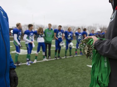 First place medals are awarded to players from the Bishop J. Mahoney Saints after they defeated the Marion Graham Falcons in the Saskatoon 3A high school football finals at SMF Field in Saskatoon, October 29, 2016.