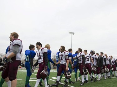 Players from both Marion Graham Falcons and Bishop J. Mahoney Saints shake hands after the game during the Saskatoon 3A high school football finals at SMF Field in Saskatoon, October 29, 2016.