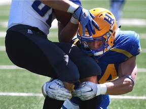 Saskatoon Hilltops' Cody Peters takes down Winnipeg Rifles' Xander Tachinski in their 2016 Prairie Football Conference season-opener at SMF Field on August 14, 2016. (Michelle Berg / The StarPhoenix)