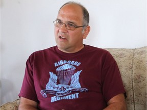 Dave Bona speaks about his experience in the armed forces suffering from the side-effects of an anti-malaria drug with his dog Aras by his side at his home in St. Denis on May 17, 2016.  (Michelle Berg / Saskatoon StarPhoenix)