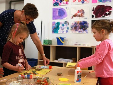 Giorgi Courteau and Jesmond Thompson make crafts in the Firefly room during the official opening of the newest USSU childcare centre at the McEown location in Saskatoon on October 17, 2016.