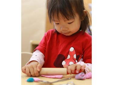 Raven Liu rolls some play doh in the Butterfly room during the official opening of the newest USSU childcare centre at the McEown location in Saskatoon on October 17, 2016.