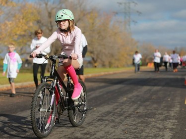 A participant rides her bike at Canadian Breast Cancer Foundation's CIBC Run for the Cure at Prairieland Park in Saskatoon on October 2, 2016.