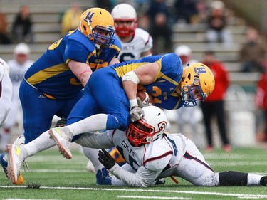 Saskatoon Hilltops' Logan Fischer is tackled to the ground during the Prairie Football Conference championship game against the Calgary Colts at SMF field in Saskatoon on October 30, 2016.